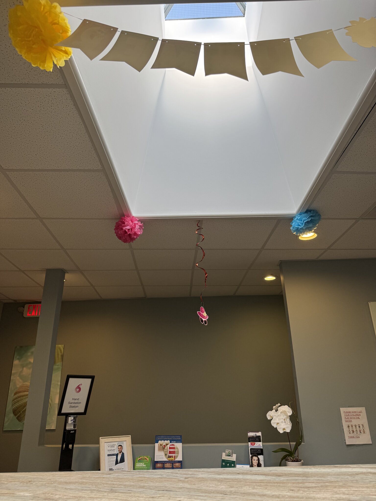 Comfort Dental at Glen Cove front desk and reception area with festive ceiling decorations